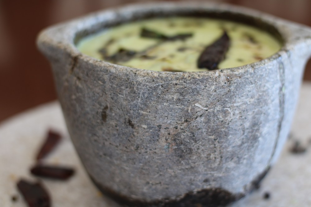 Traditional South Indian morkootan yogurt curry in a stone vessel (Kalchatti)
